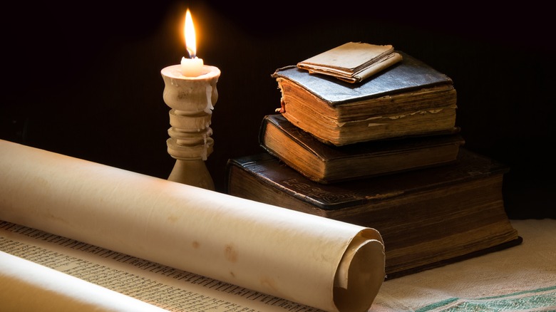 The Talmud next to a lit candle