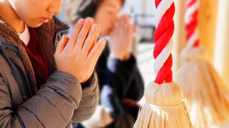 Young Japanese man visiting temple