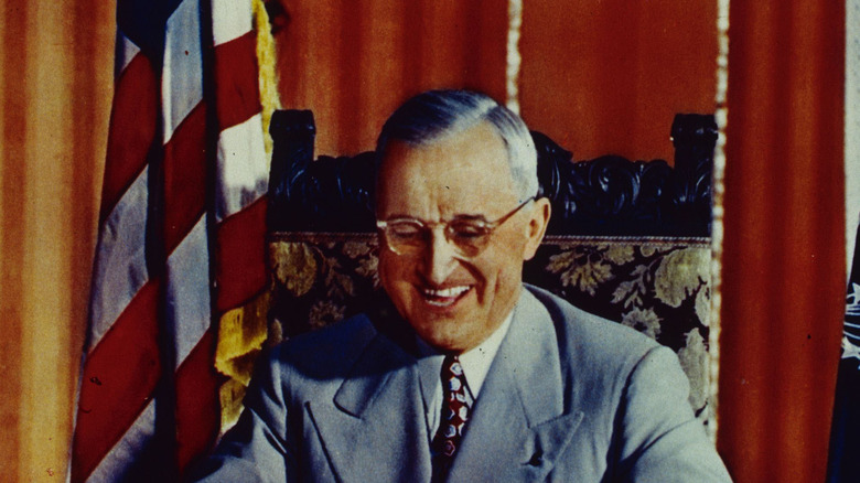 harry truman seated desk