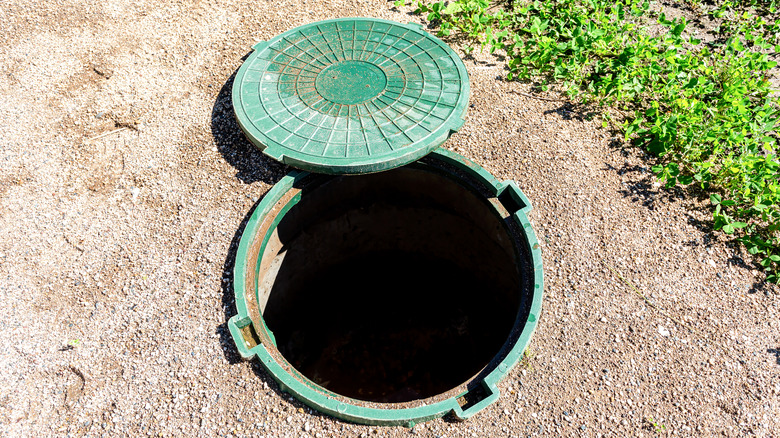 Open septic tank green cover