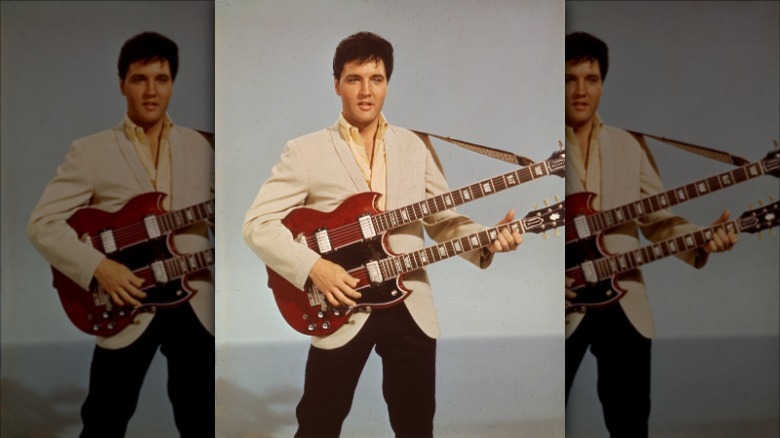 Elvis Presley standing with guitar