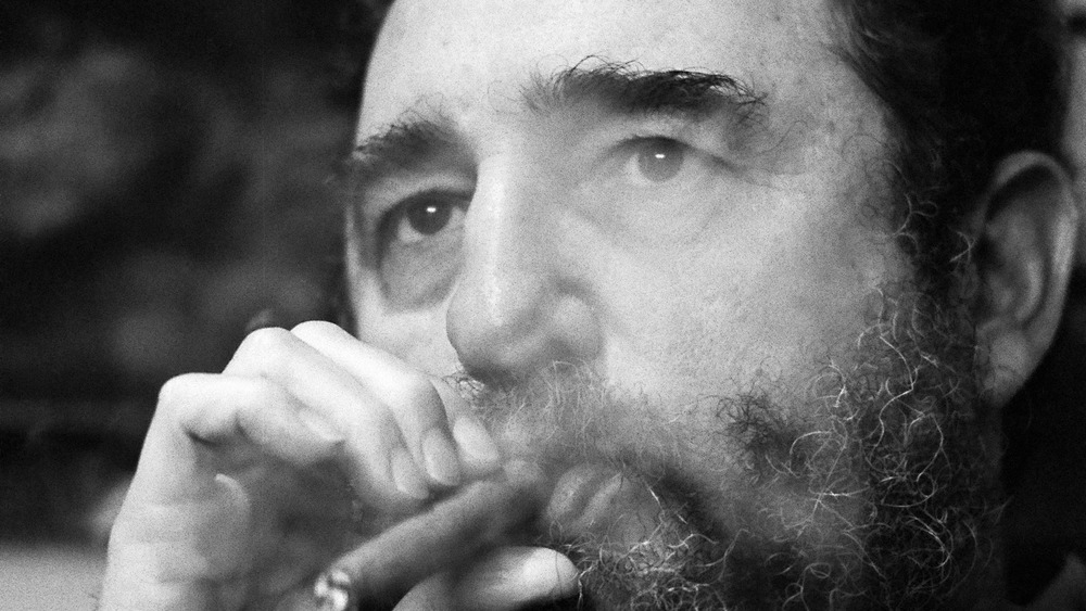 Fidel Castro smokes a cigar