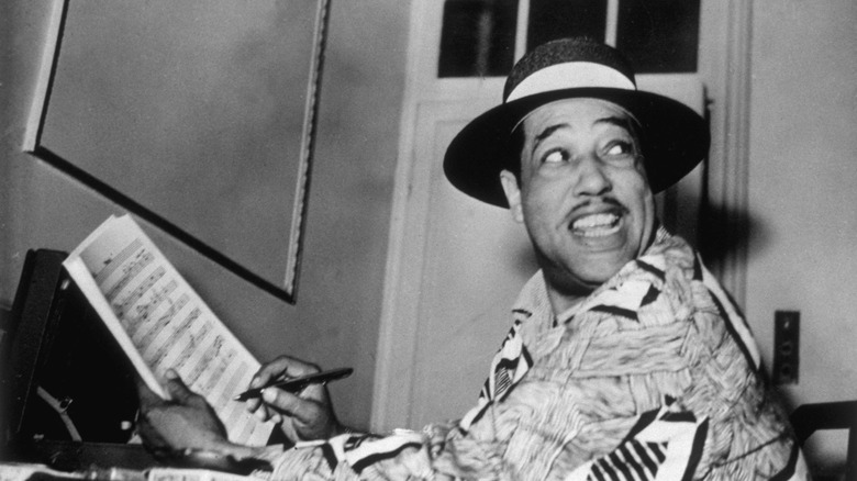 duke ellington writing music smiling