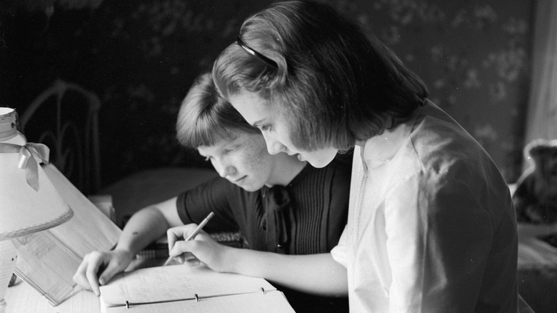 Teenagers do homework in 1955