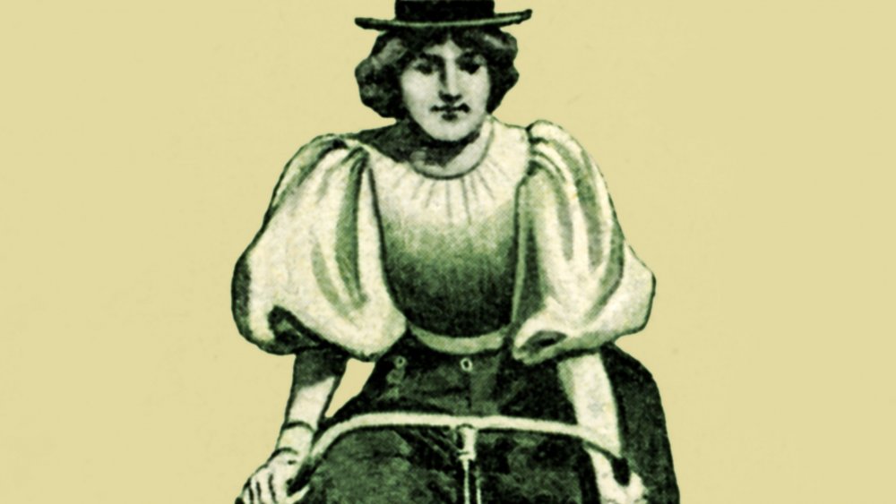 Pants wearing woman on bike