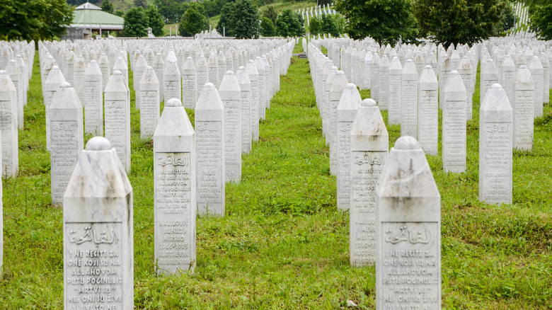 Mass grave with white tombstones