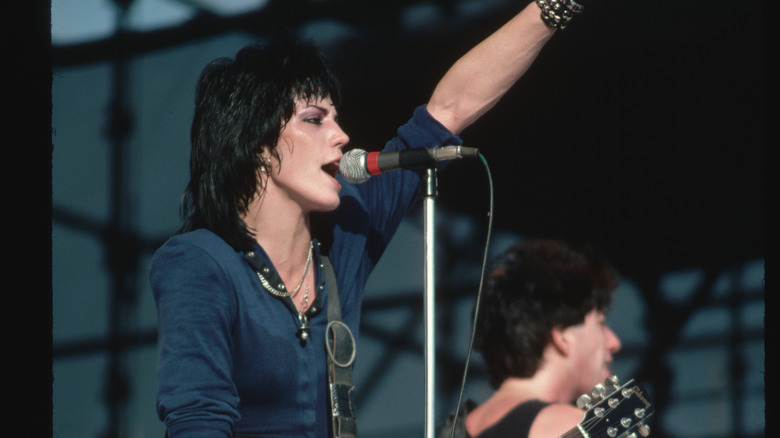 Joan Jett performing hand raised