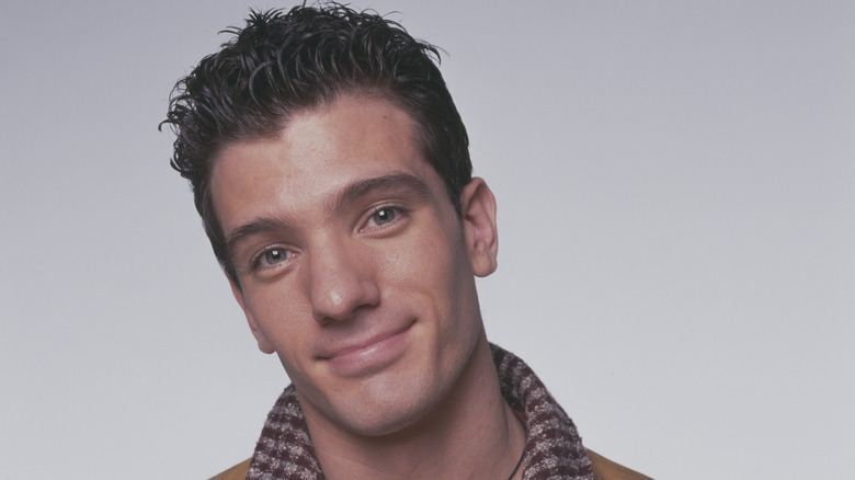 JC Chasez smiling in brown jacket