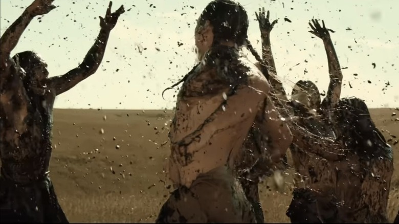 Osage men dance in an oil gush