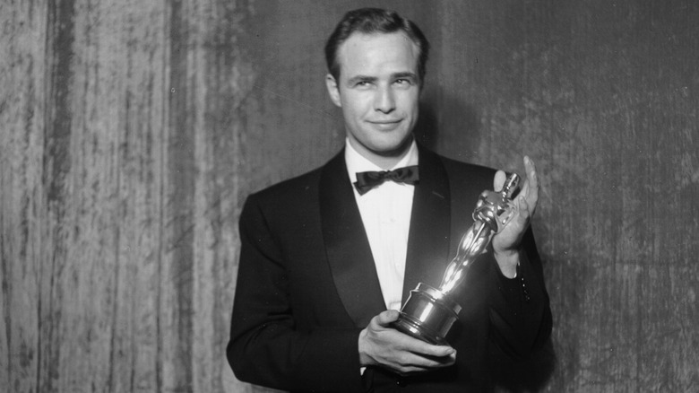 Marlon Brando holding his Academy Award 