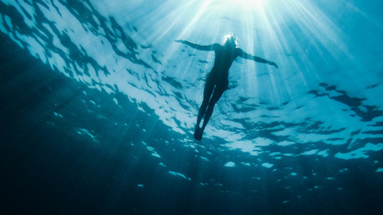 Underwater view of a woman floating at sea