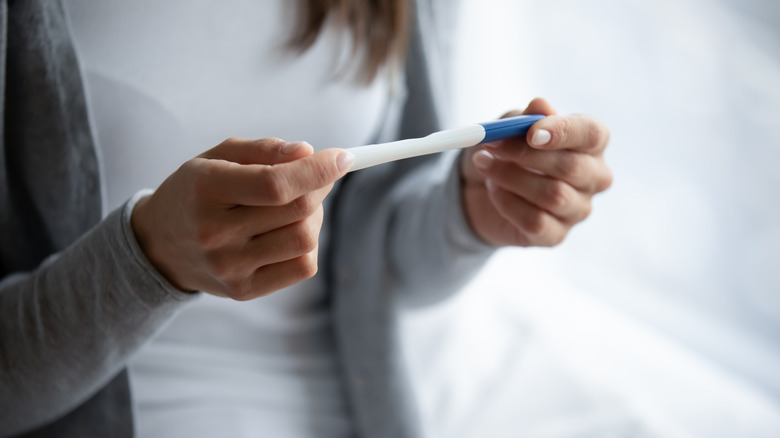 Woman with pregnancy test