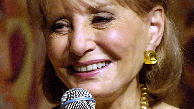 Barbara Walters smiling with mic