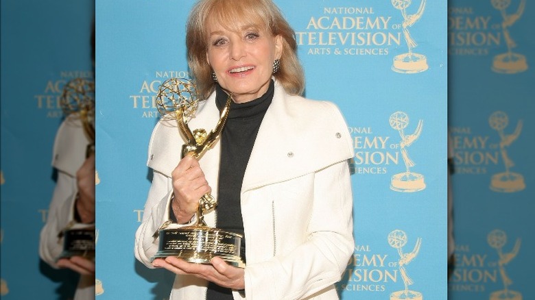 Barbara Walters holding Emmy award