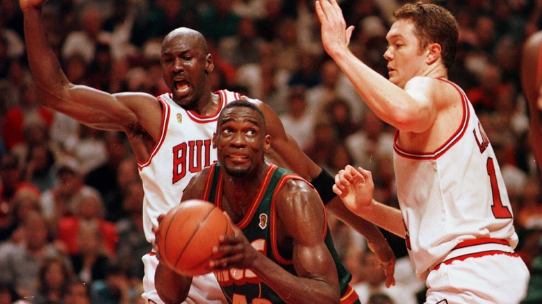 Michael Jordan and Luc Longley defend Shawn Kemp