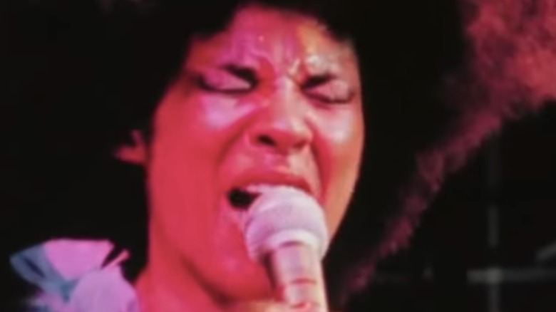 Betty Davis on stage with microphone