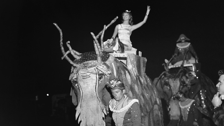 Vikki Dougan riding an elephant, 1957