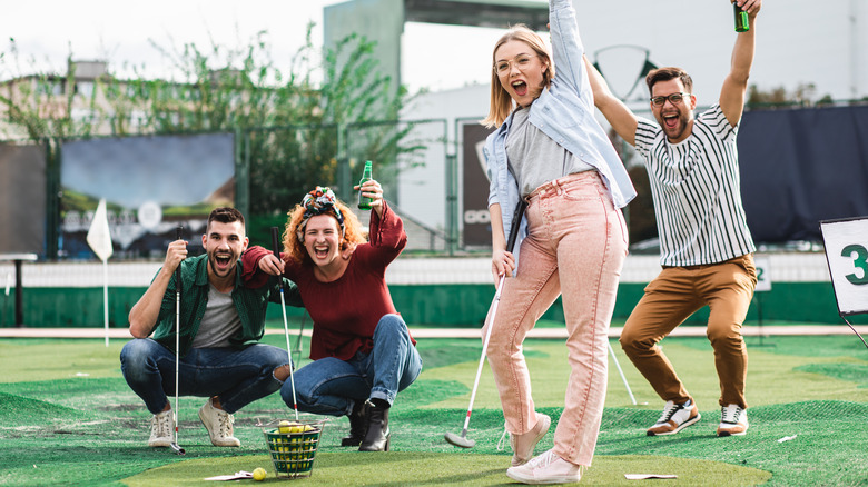 A group playing mini golf 