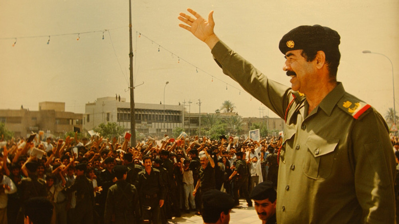 Saddam Hussein greeting people