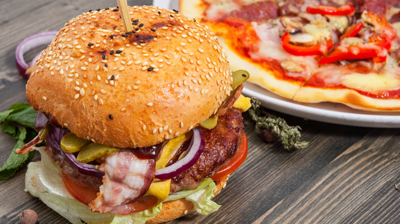 cheeseburger and pizza on a table