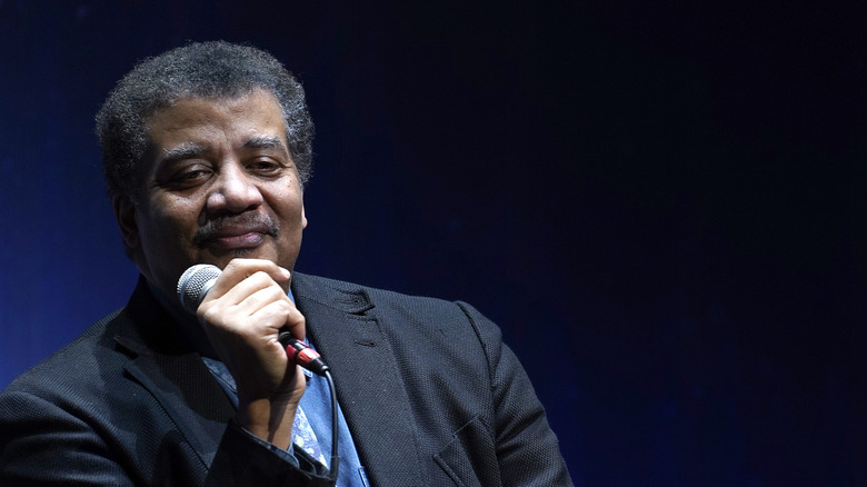 Neil deGrasse Tyson on stage with microphone