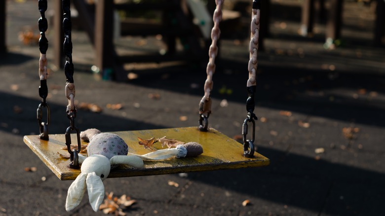 Empty swing with child's toy