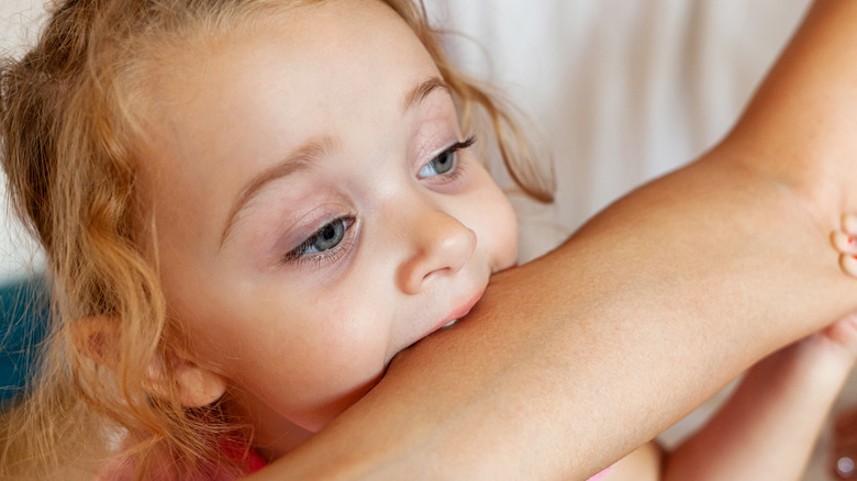 Toddler biting arm 