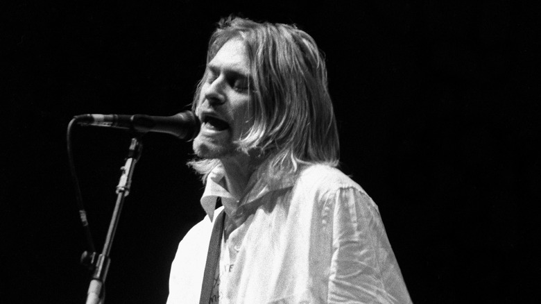 Kurt Cobain of Nirvana singing into a microphone