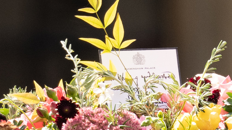 A card sticks up behind flowers