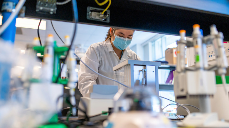 Researcher adjusting bioprinter