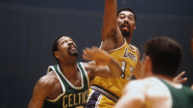 Wilt Chamberlain shoots over Bill Russell