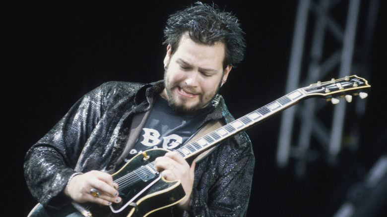 Chad Taylor playing guitar spiky hair