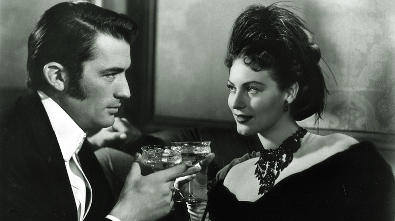 Ava Gardner shares a drink with Gregory Peck