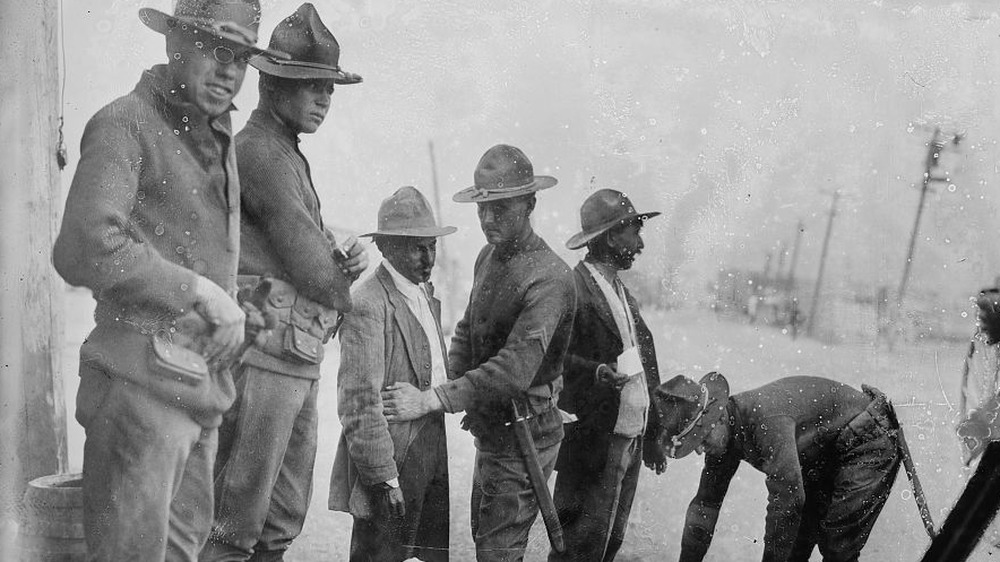 Soldiers searching Mexican people in El Paso between 1915 and 1920