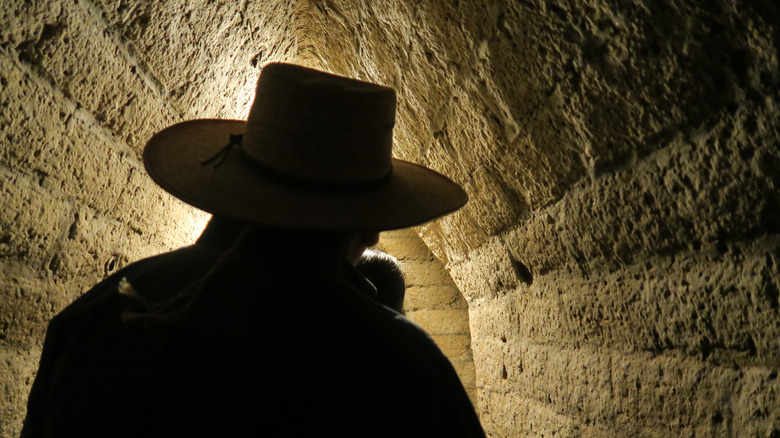 Man in silhouette before tunnel