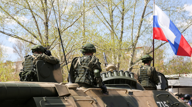 Russian soldiers atop tanks