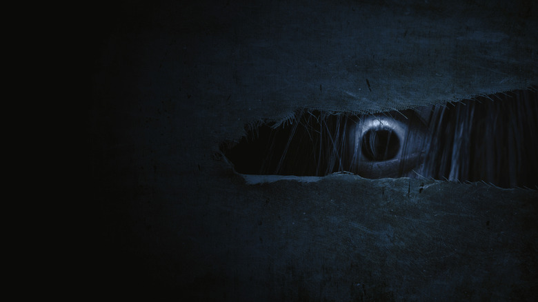 Evil eye through wall crack