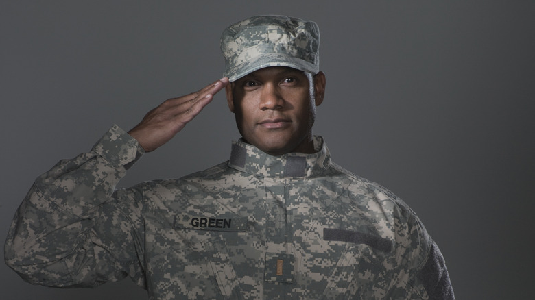 soldier saluting in camo uniform