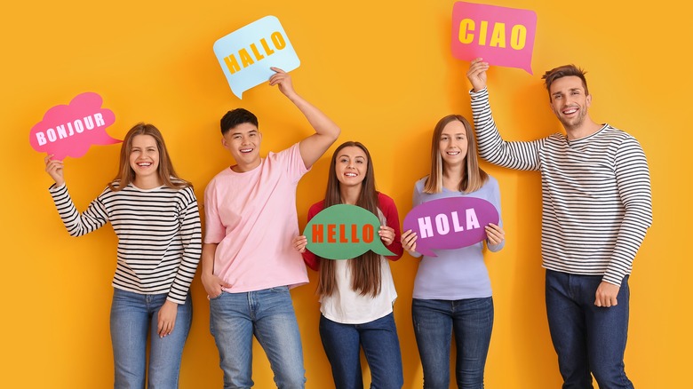 people holding signs in different languages