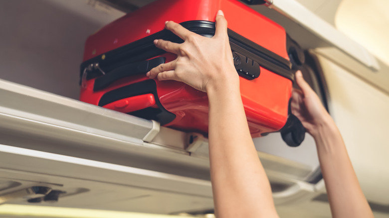 luggage in overhead compartment