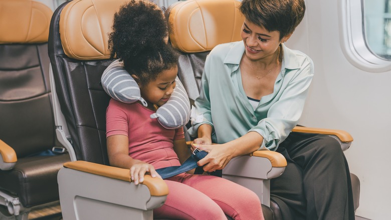 helping kid with seat belt