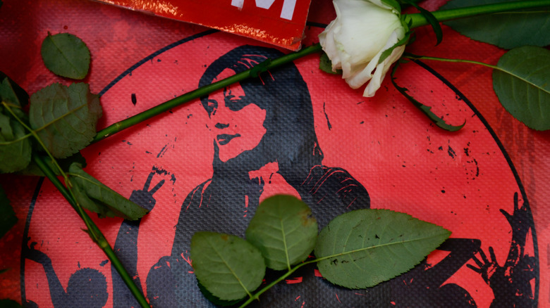 victim memorial with white rose of silhouette