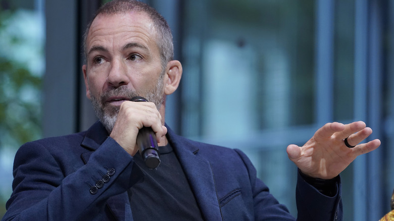 Bryan Callen gesturing while speaking into a microphone