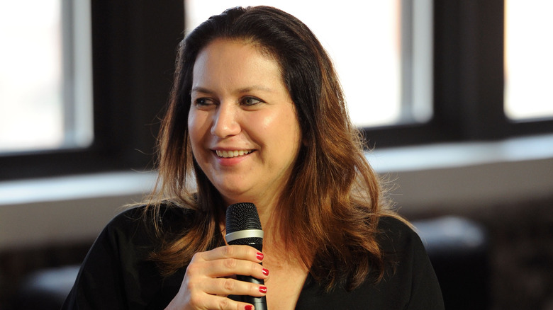 Rukmini Callimachi smiling speaking into a microphone