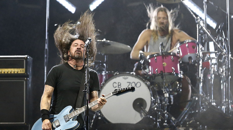 dave grohl and taylor hawkins playing onstage with foo fighters