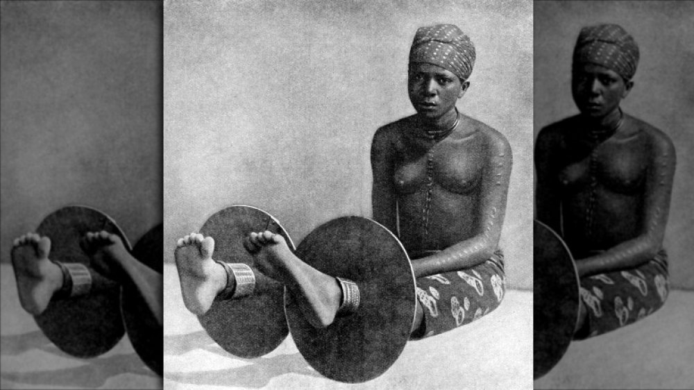 An Igbo woman wearing ankle plates, Nigeria, West Africa, 1922.