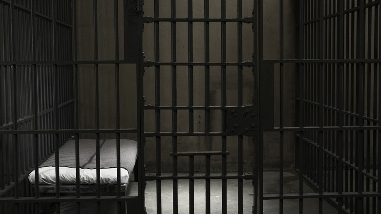 dark jail cell bed