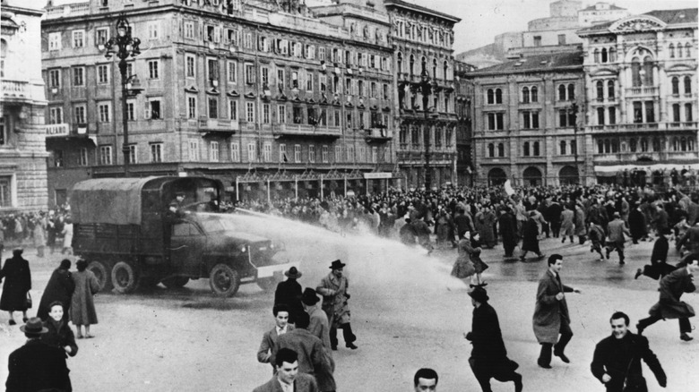 Trieste Riots men in streets car gushing water