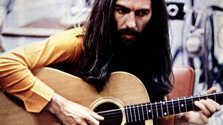 George Harrison plays guitar
