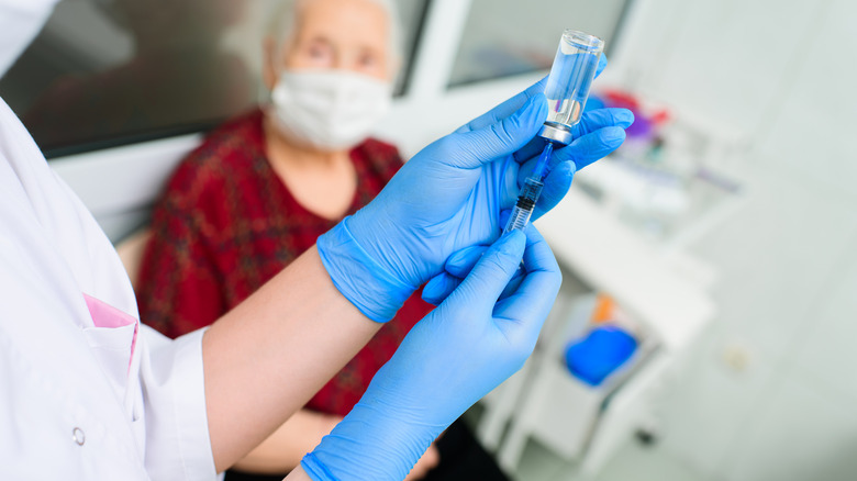 Doctor preparing morphine vial